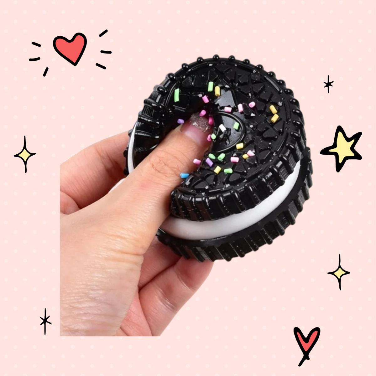 Foundry FitFit Oreo style sandwich biscuit squishy toy with colorful sprinkles being squeezed by a hand