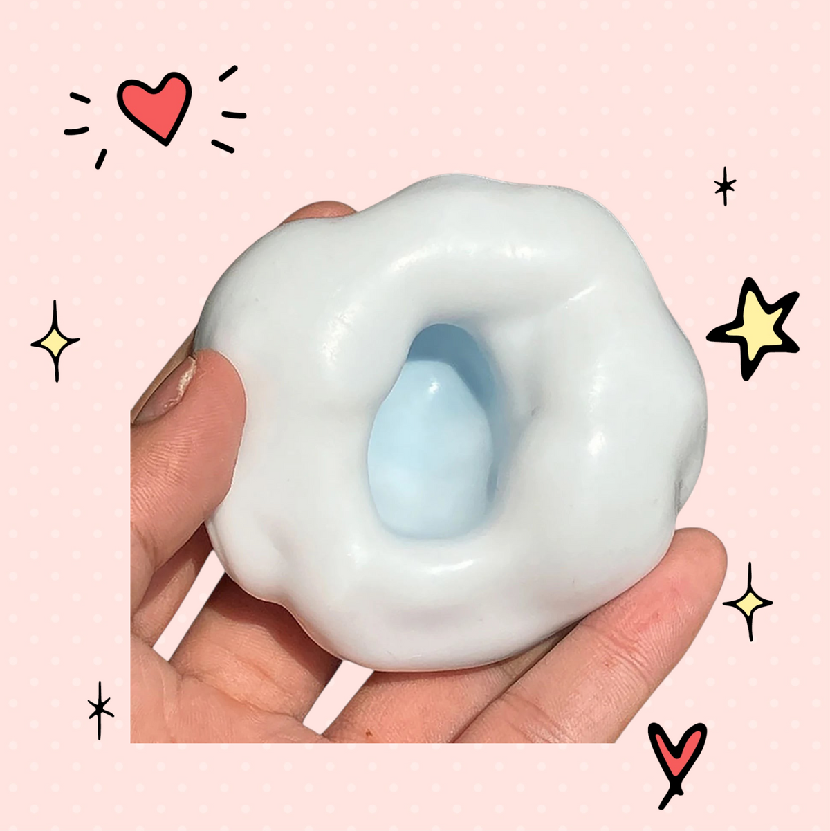 Foundry FitFit white and light blue squishy stress relief sand ball being held in a hand for sensory anxiety relief