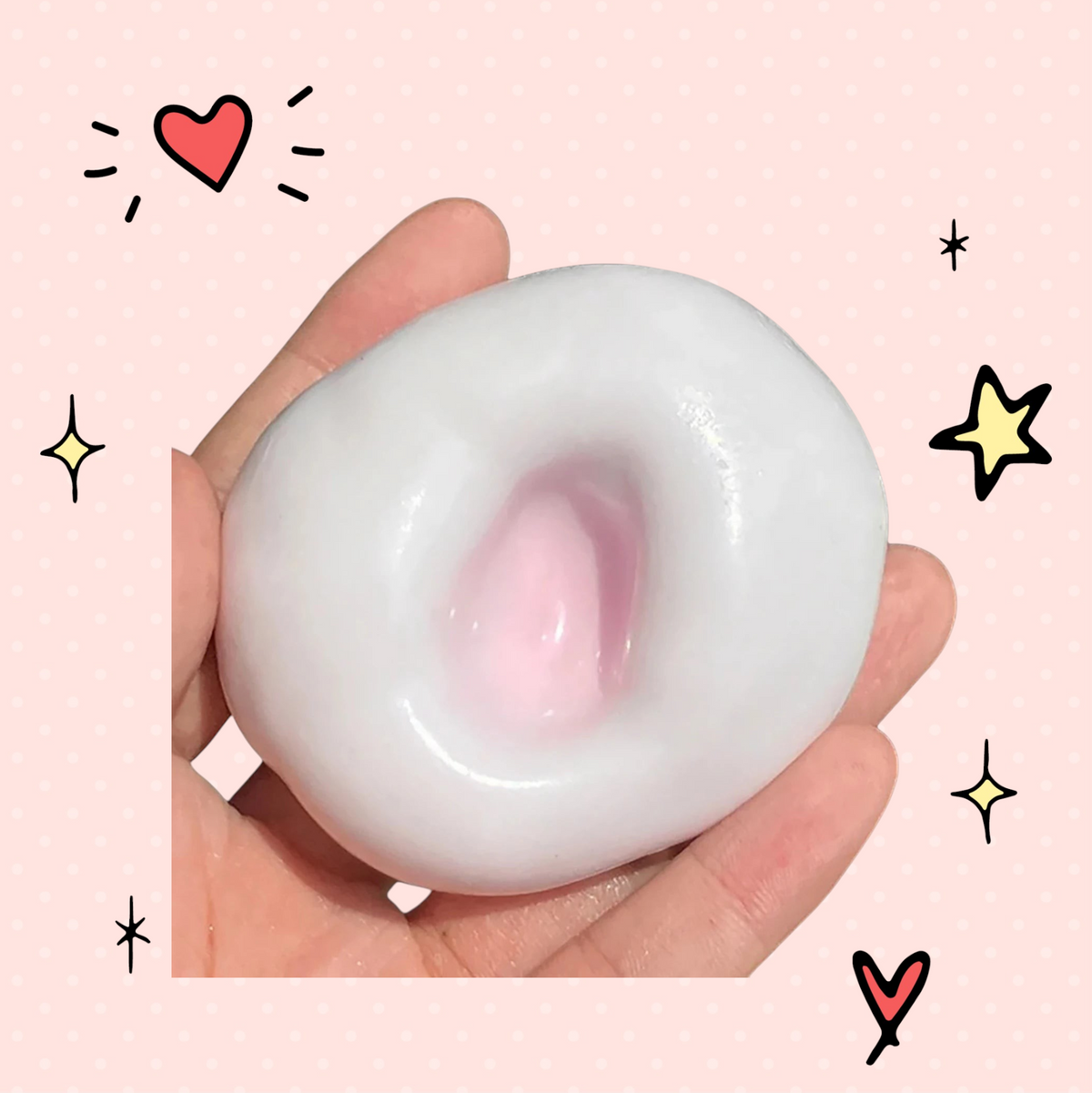 Foundry FitFit white and pink glutinous sand stress relief ball held in hand for sensory anxiety relief