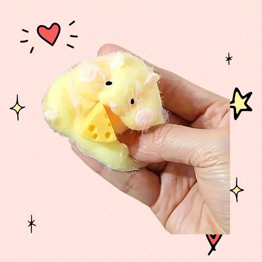 Foundry FitFit soft yellow and white hamster squishy toy holding a small piece of cheese held in a hand