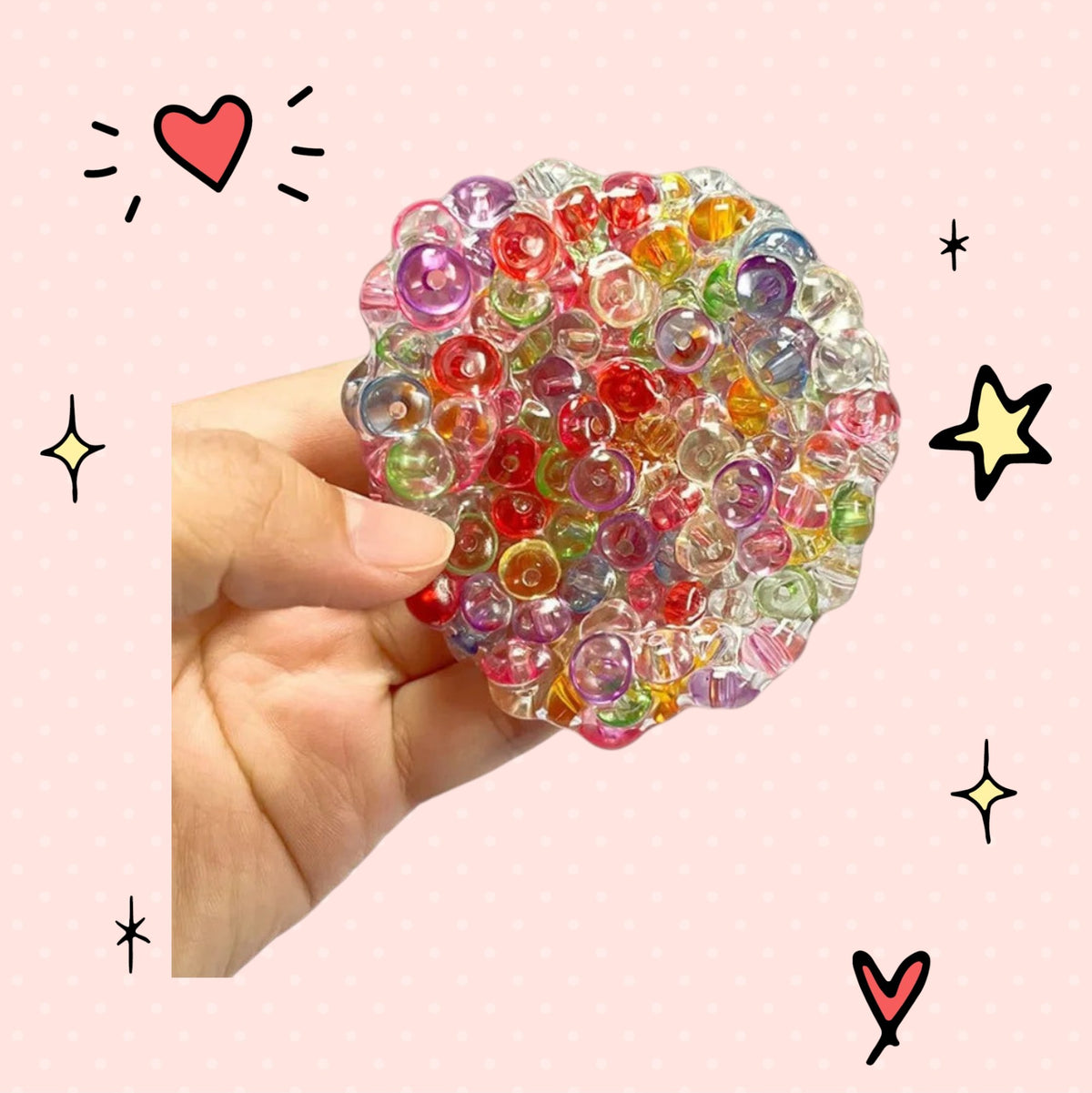 Foundry FitFit multi-colored gel bead squishy ball for sensory stress relief held in a hand