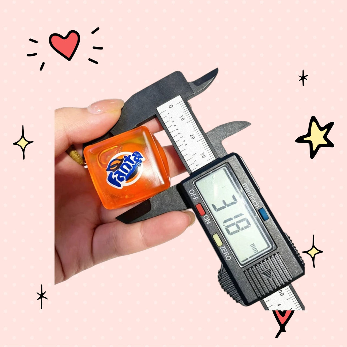 Foundry FitFit orange Fanta soda-themed squishy toy being measured with digital calipers for size reference