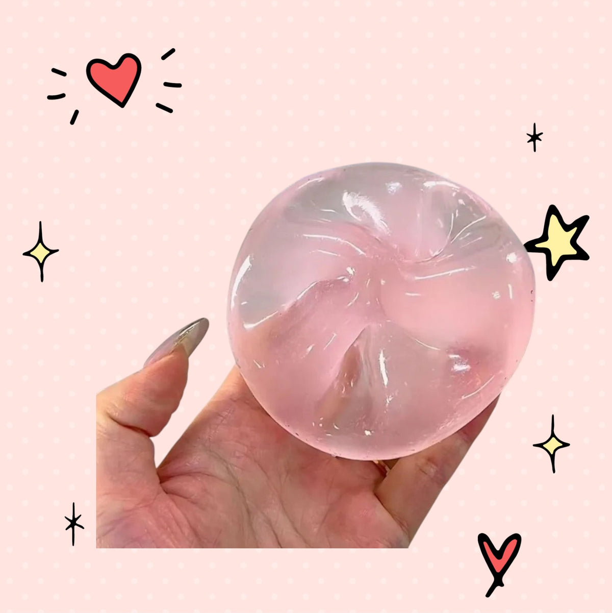 Foundry FitFit pink transparent squishy ball with a jelly-like texture being squeezed in a hand for stress relief.
