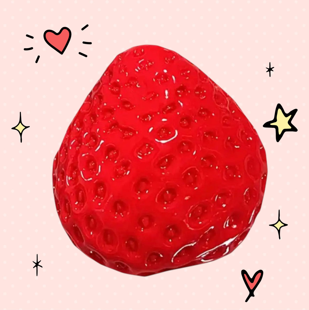 Foundry FitFit red strawberry squishy stress relief toy with cute hand-drawn heart and star doodles on a pink background