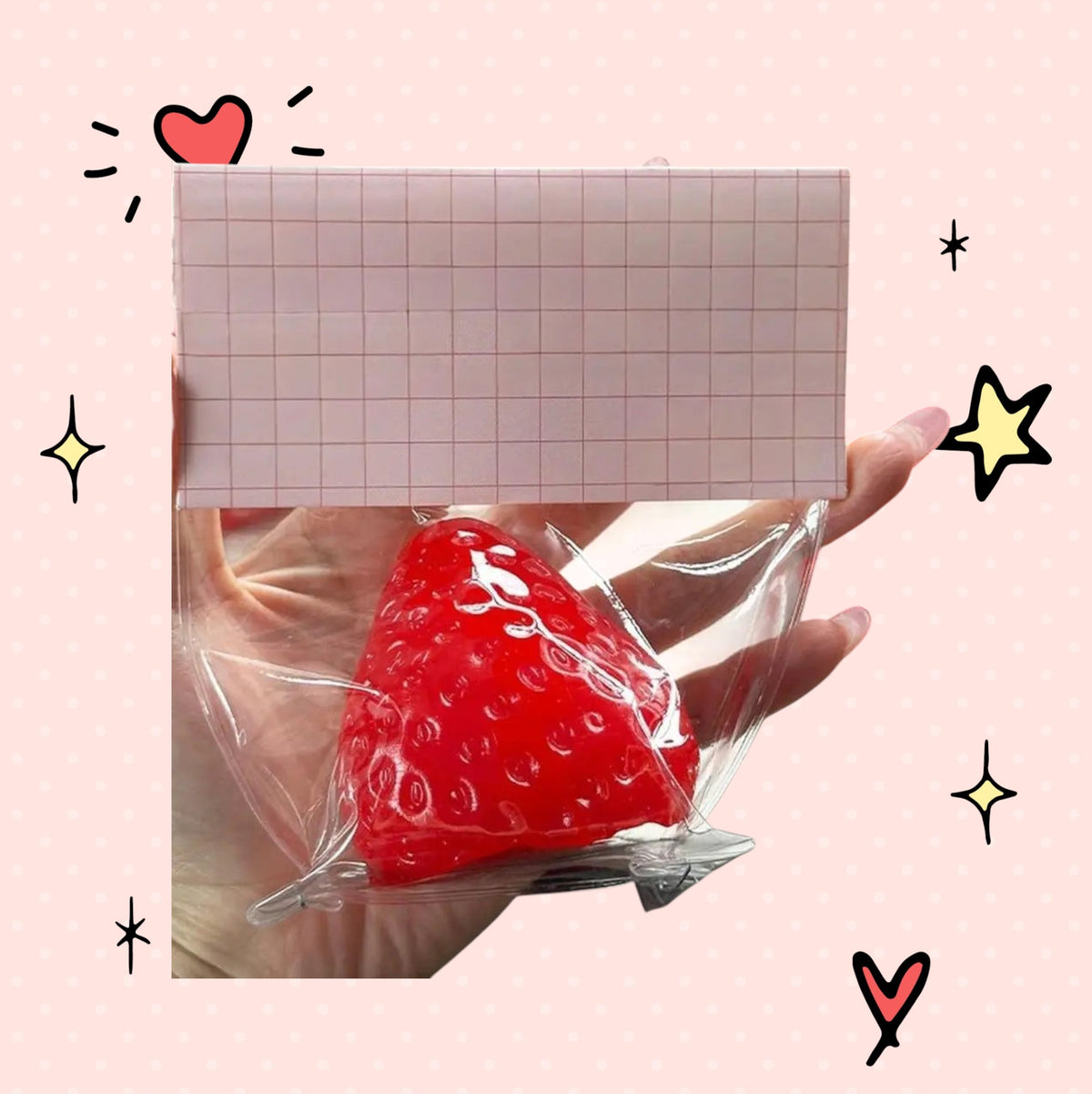 Foundry FitFit red strawberry squishy stress relief toy in clear packaging held in a hand