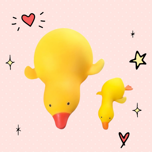 Foundry FitFit yellow squishy duck fidget toys for stress relief held in hands against a window background