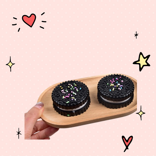 Foundry FitFit Oreo style sandwich cookie squishy toy with colorful sprinkles on a wooden tray for stress relief