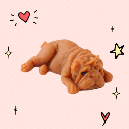 Foundry FitFit brown puppy squishy toy with a sleepy kawaii expression on a pink background with doodle stars and hearts