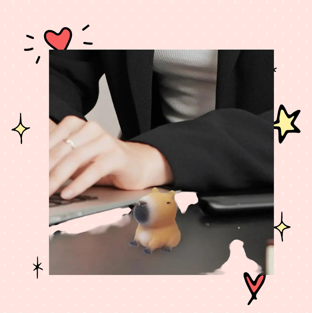 Foundry FitFit capybara squishy sensory toy sitting on a desk next to a person working on a laptop