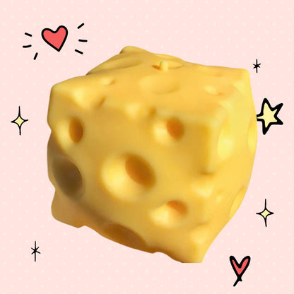 Foundry FitFit yellow cheese block squishy fidget toy with realistic holes on a pink background with doodle accents
