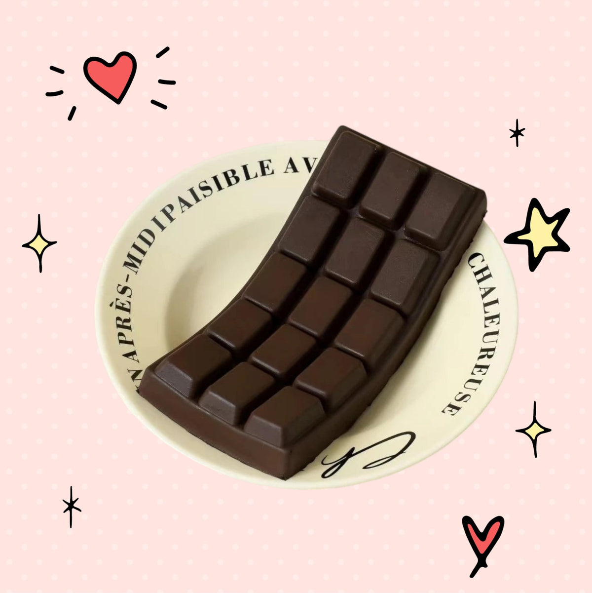 Foundry FitFit dark brown chocolate bar squishy stress reliever made of soft slow-rebound PU foam on a ceramic plate.