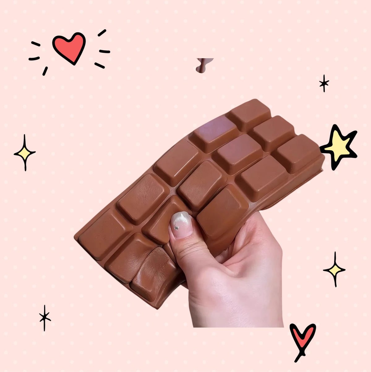 Foundry FitFit brown chocolate bar squishy being squeezed by a hand, showing slow-rebound PU material texture.