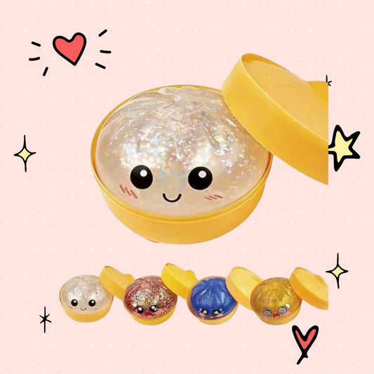 Foundry FitFit dumpling-shaped squishy toy with a cute face and glittery finish in a yellow storage container