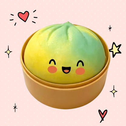 Foundry FitFit green and yellow dumpling squishy toy with a happy smiling face in a small bamboo-style container