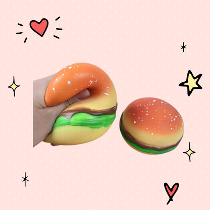 Foundry FitFit hamburger squishy toy being squeezed to show soft TPR material for stress relief and sensory play.