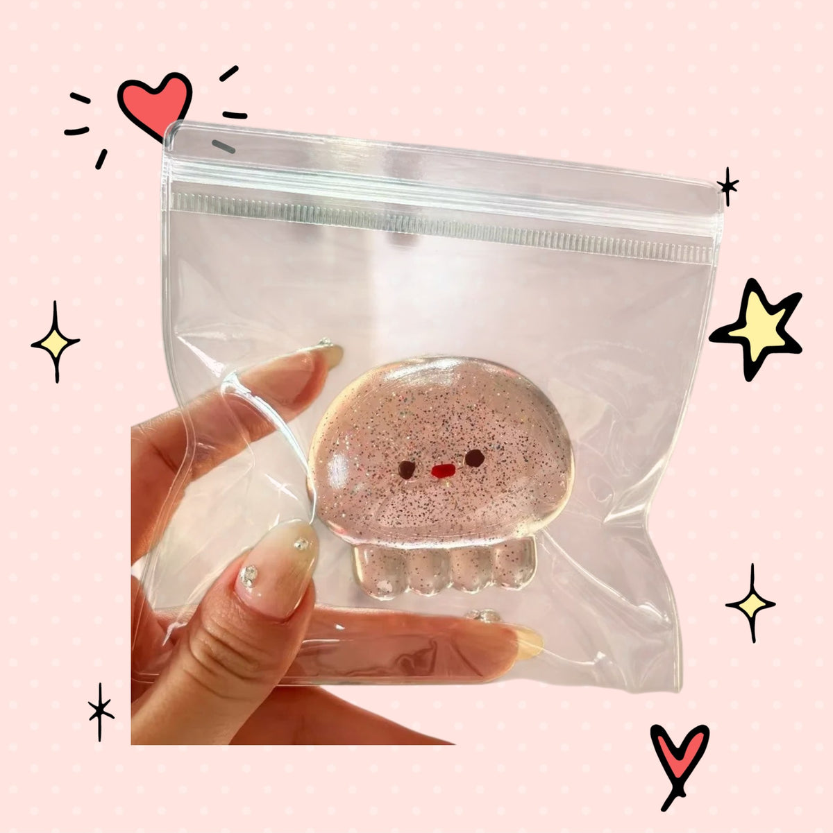 Foundry FitFit transparent glittery jellyfish squishy toy held in a hand, perfect for stress relief and fidgeting.
