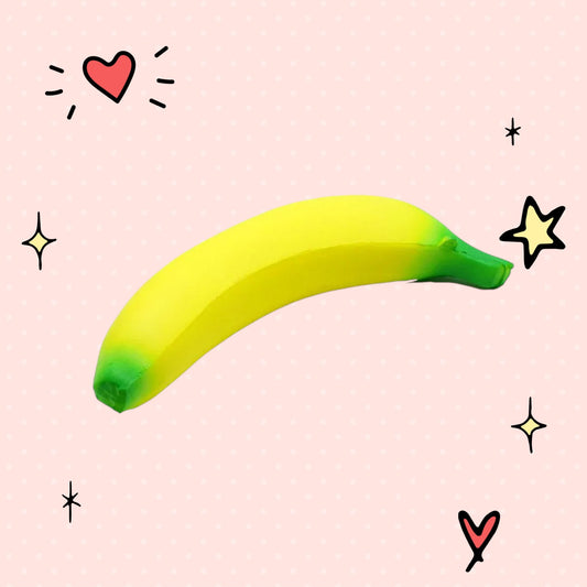 Foundry FitFit jumbo yellow banana squishy toy with green tips, made of soft slow-rise foam for stress relief.