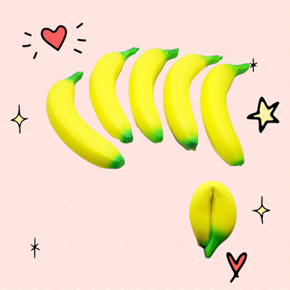 Foundry FitFit jumbo yellow banana squishy toy with green tips, showing multiple units and a hand squeezing one.