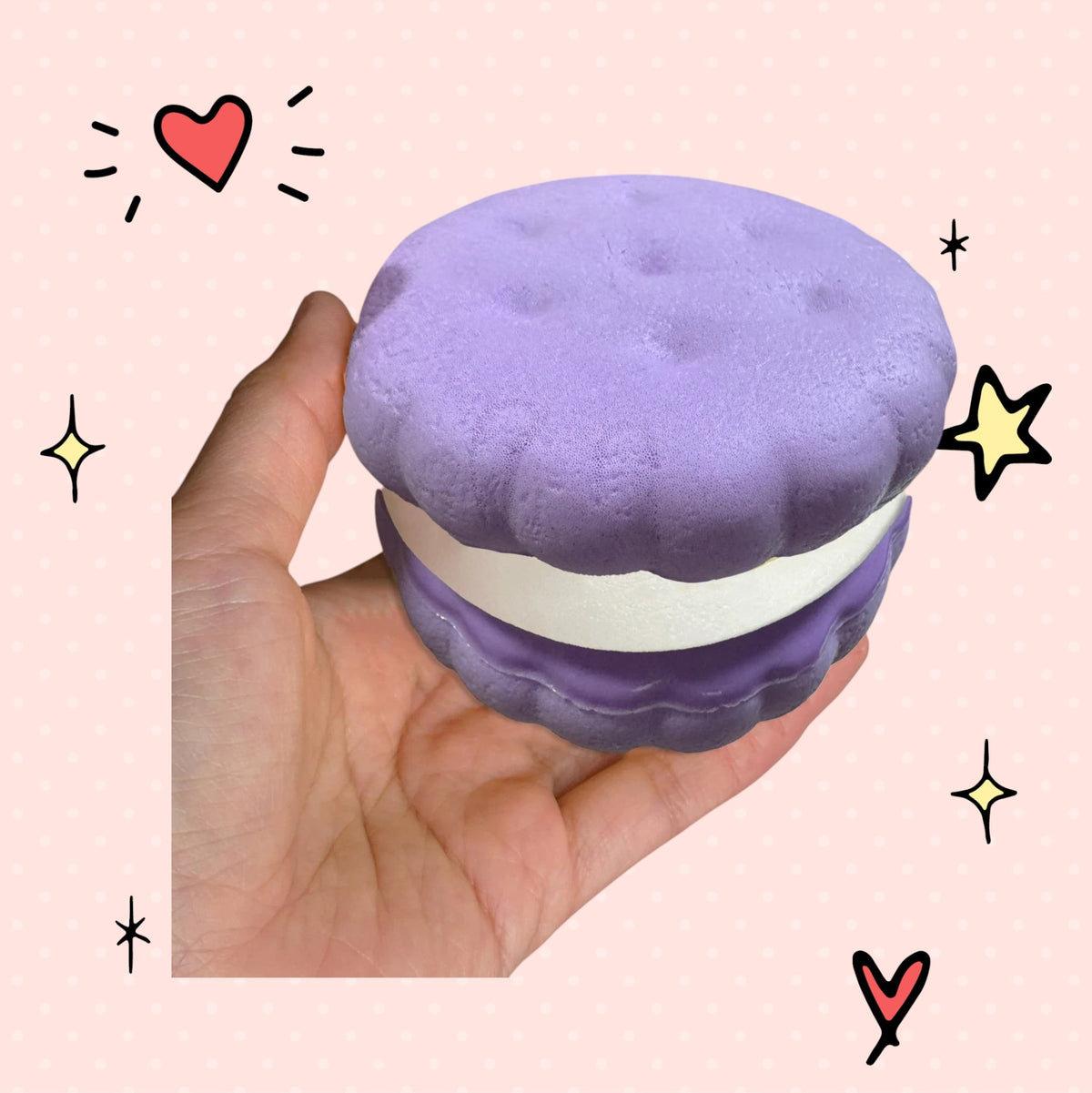 Foundry FitFit lavender sandwich-shaped slow-rise foam squishy held in a hand with other pastel squishies in background