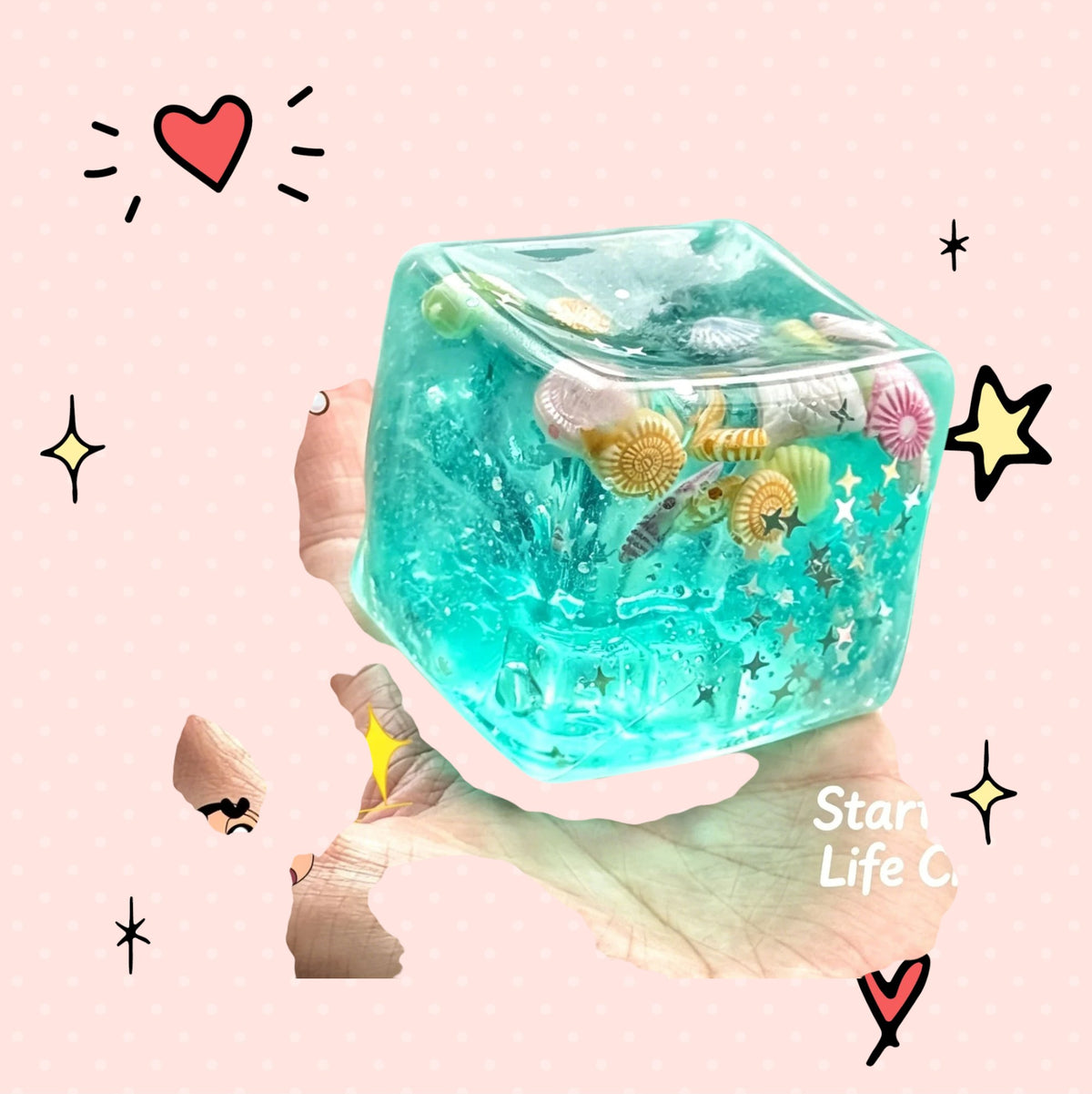 Foundry FitFit ocean-themed squishy cube with crystal-soil filling, seashells, and star glitter for sensory play.