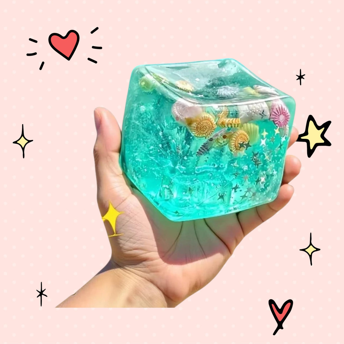 Foundry FitFit ocean-themed squishy cube filled with crystal soil and seashells held in a hand for sensory play