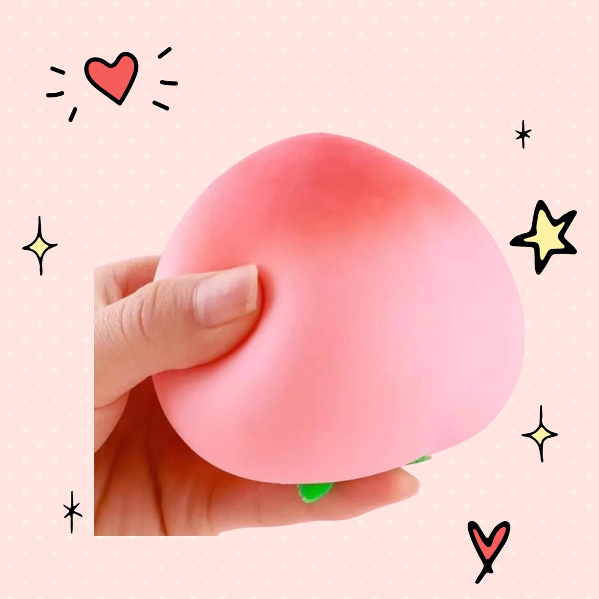 Foundry FitFit peach-shaped silicone squishy stress toy held in hand against a pink background