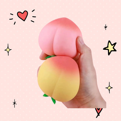 Foundry FitFit peach-shaped squishy stress relief toys in pink and yellow, held in a hand against a pink background.