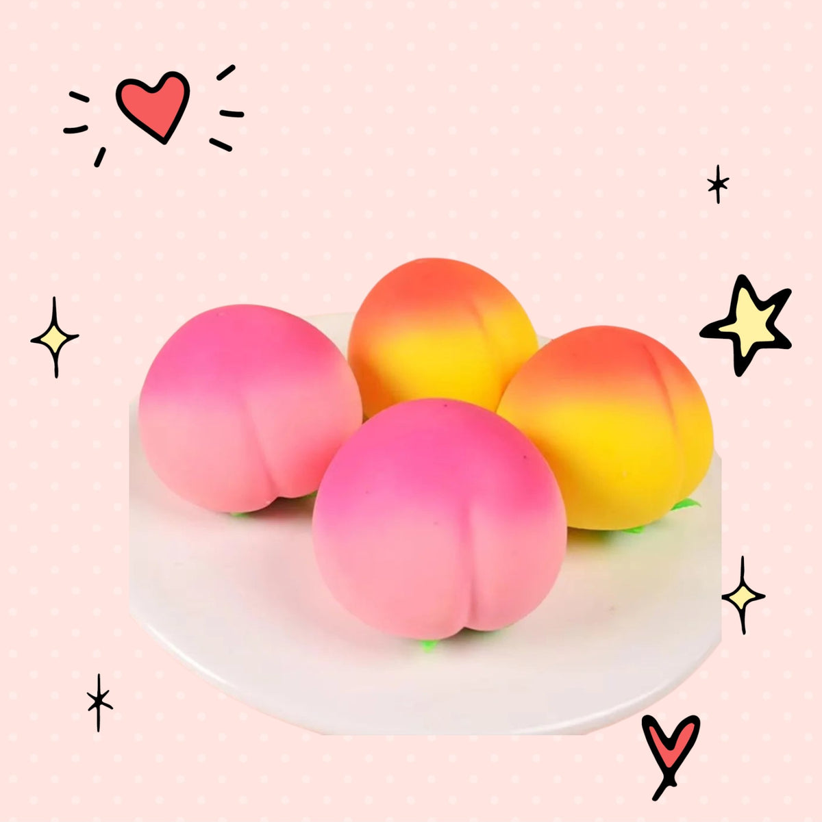 Foundry FitFit peach-shaped soft silicone squishy stress relief toys in pink and yellow on a white plate