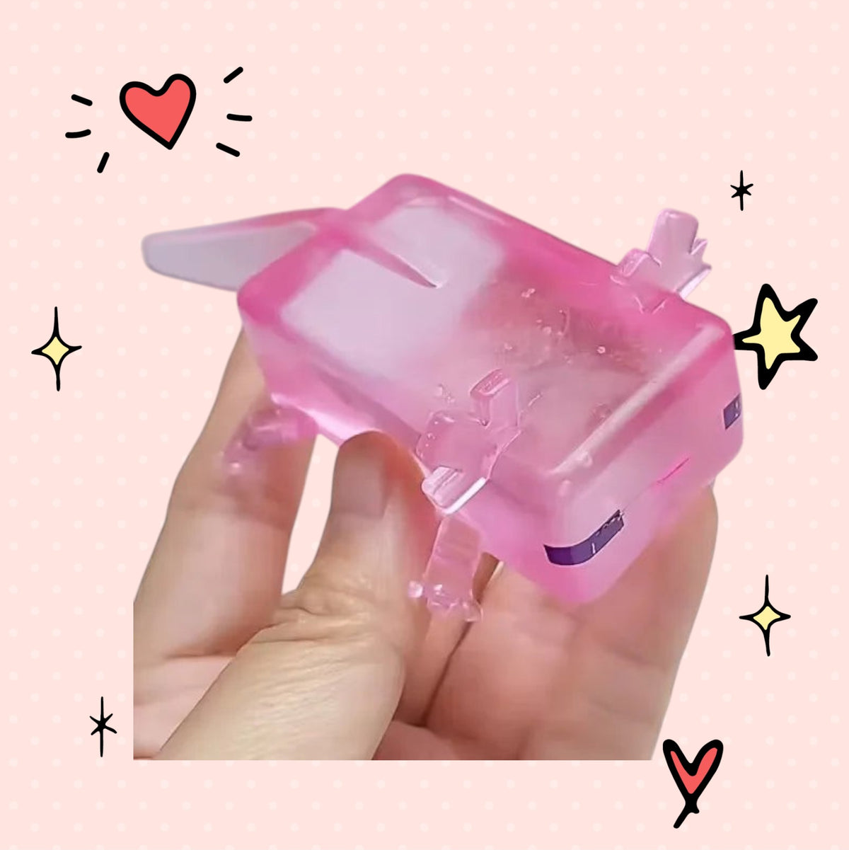 Foundry FitFit pink translucent axolotl squishy toy held in hand for stress relief