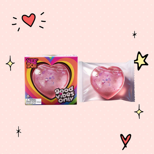 Foundry FitFit Caring Heart Squishy in pink with glitter, shown in packaging and as a loose stress-relief toy.