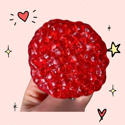 Foundry FitFit red squishy ice-bead ball held in hand for stress relief and sensory fidgeting