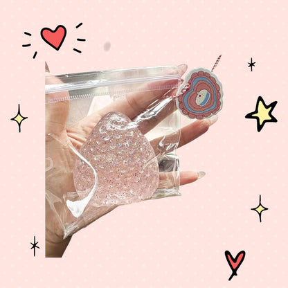 Foundry FitFit strawberry-shaped clear glitter squishy toy in a plastic bag with a decorative heart tag