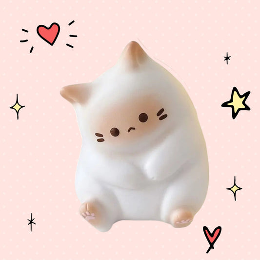 Foundry FitFit white cartoon cat squishy toy with a sad expression, made of soft polyurethane for stress relief.