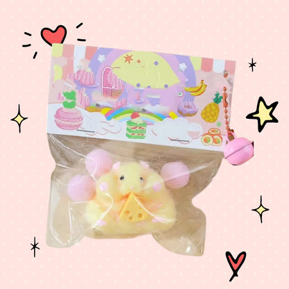 Foundry FitFit yellow hamster squishy toy with a cheese slice in clear packaging with a pink bell charm